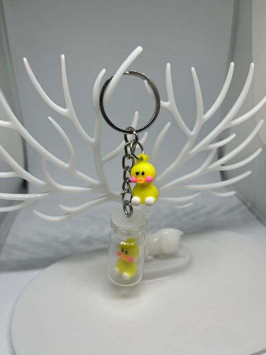 Shy duck in a bottle keychain
